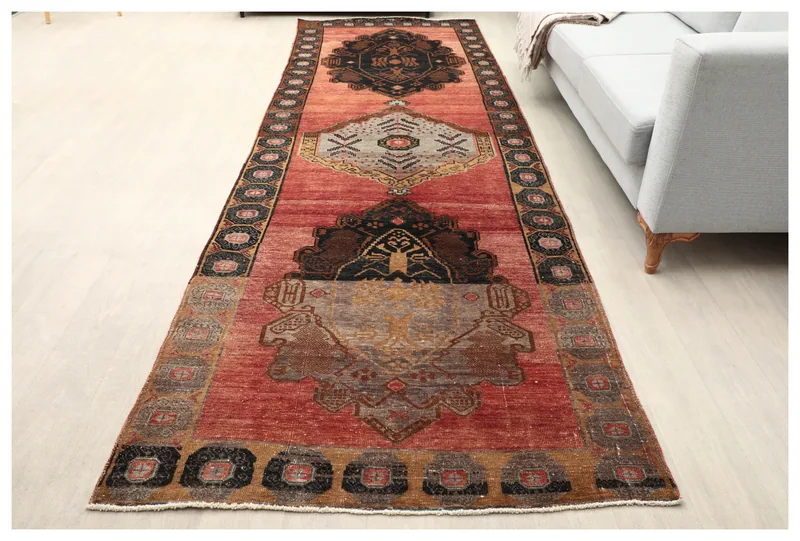 Full top view of the 4x12 Anatolian runner rug with red field and black, gray, tan geometric patterns