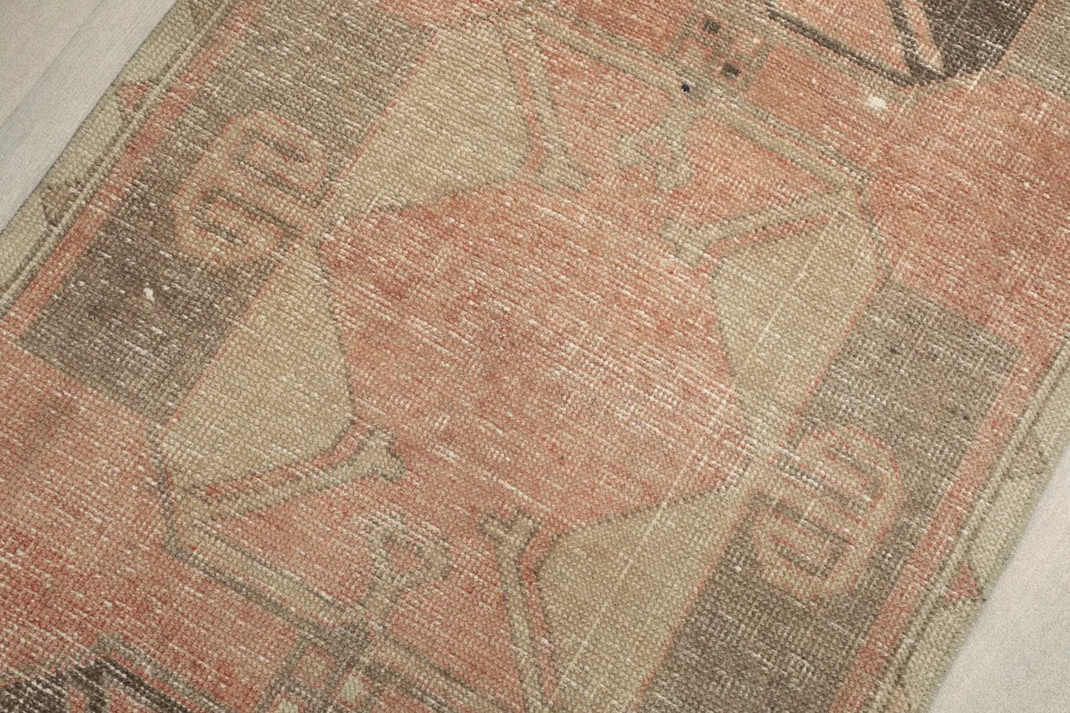 Textural close-up of the low wool pile, revealing the distressed finish and color blending.