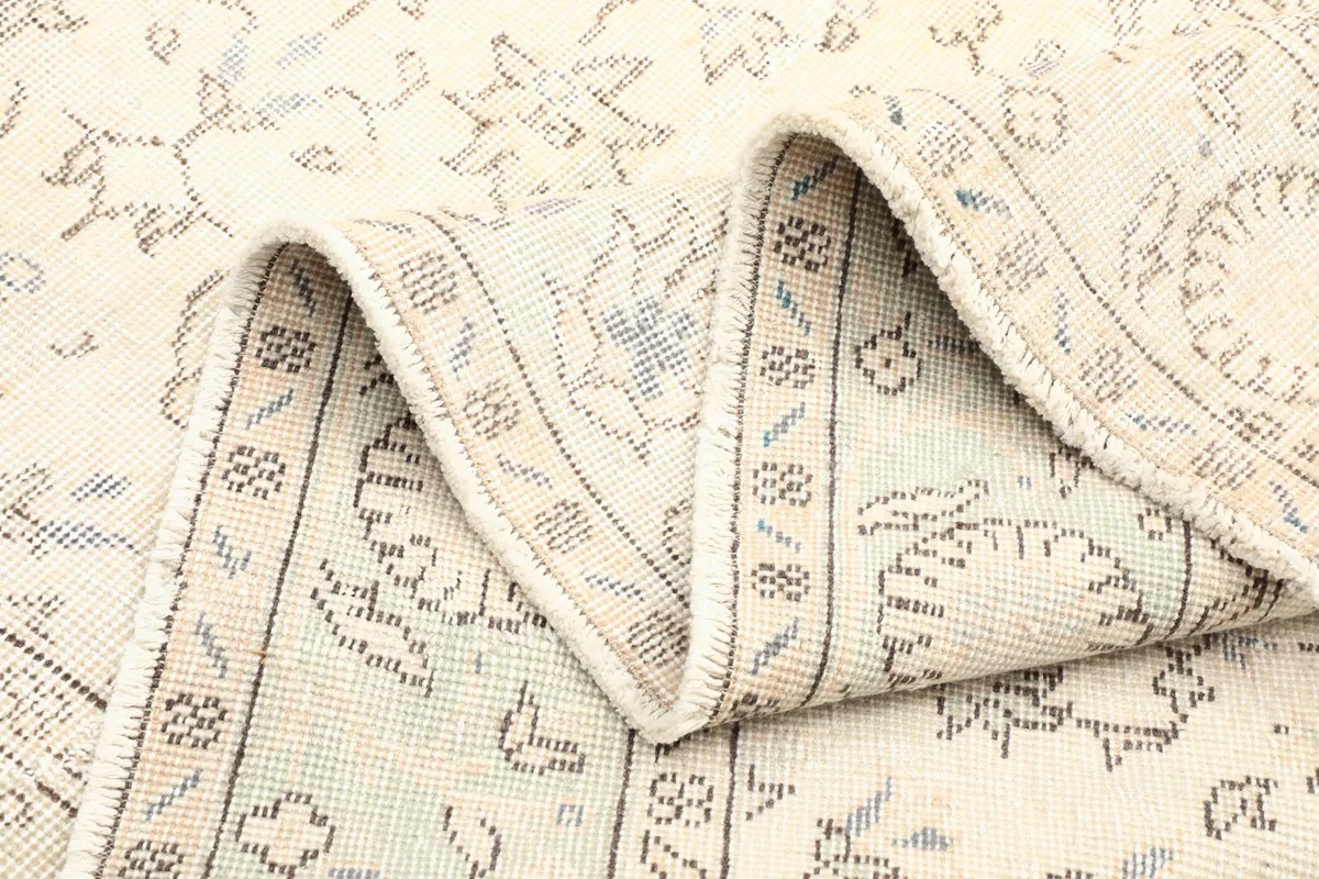 Folded section of the rug, showing the back and the density of the hand-knotted construction