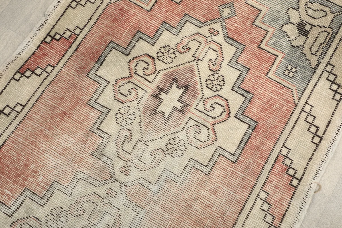 Central medallion detail of the hand-knotted vintage runner, showcasing intricate patterns.