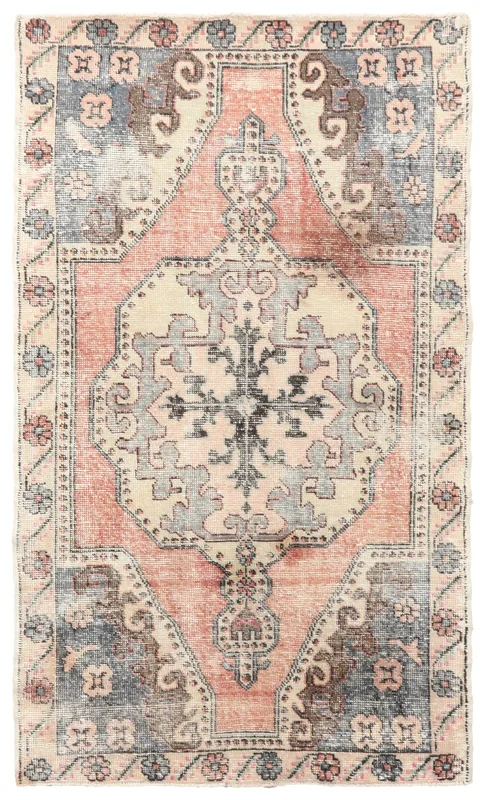Full top view of the vintage rose and blue medallion Anatolian rug on a white background