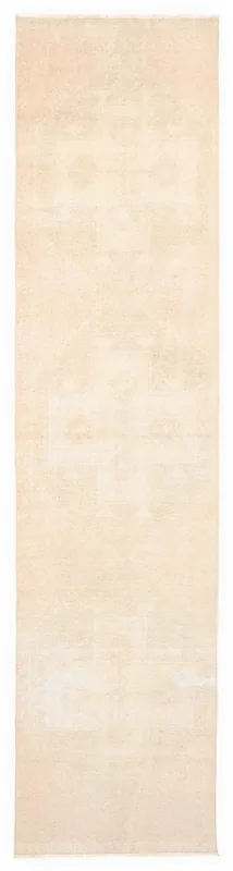 Full overhead view of the beige and rose vintage Anatolian runner rug on a white background.