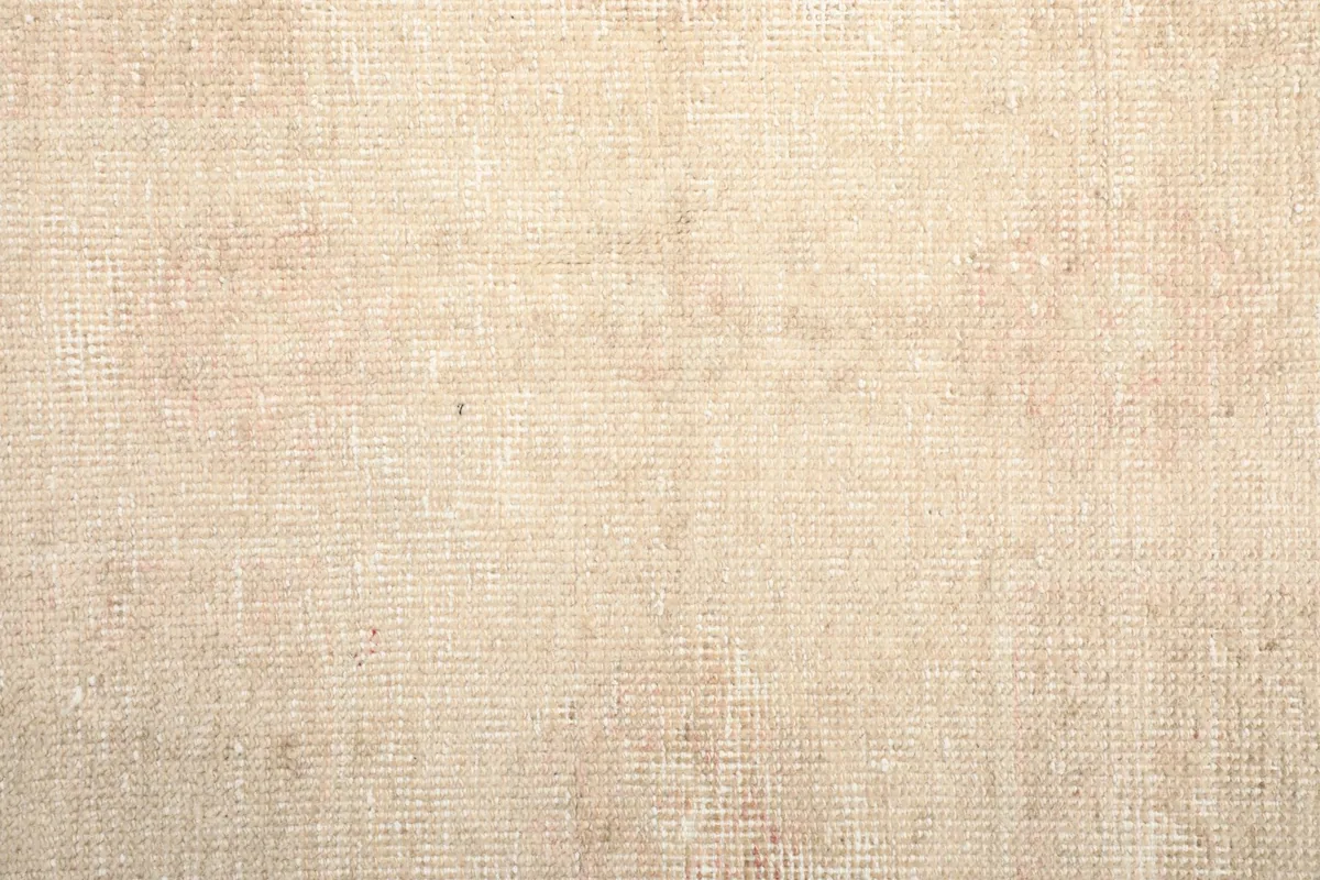 Close-up of the rug's backside, showing the hand-knotted cotton foundation.