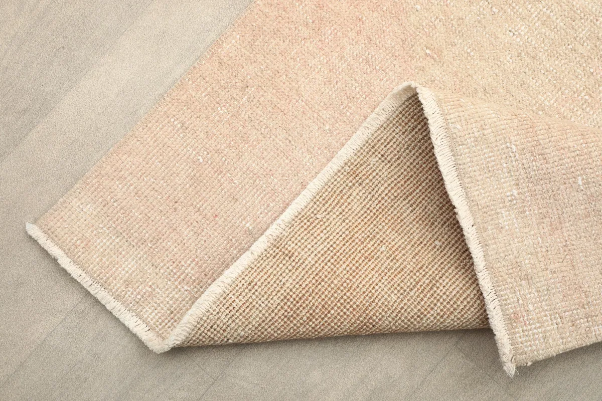 Folded section of the runner, displaying the wool pile on the front and cotton foundation on the back.