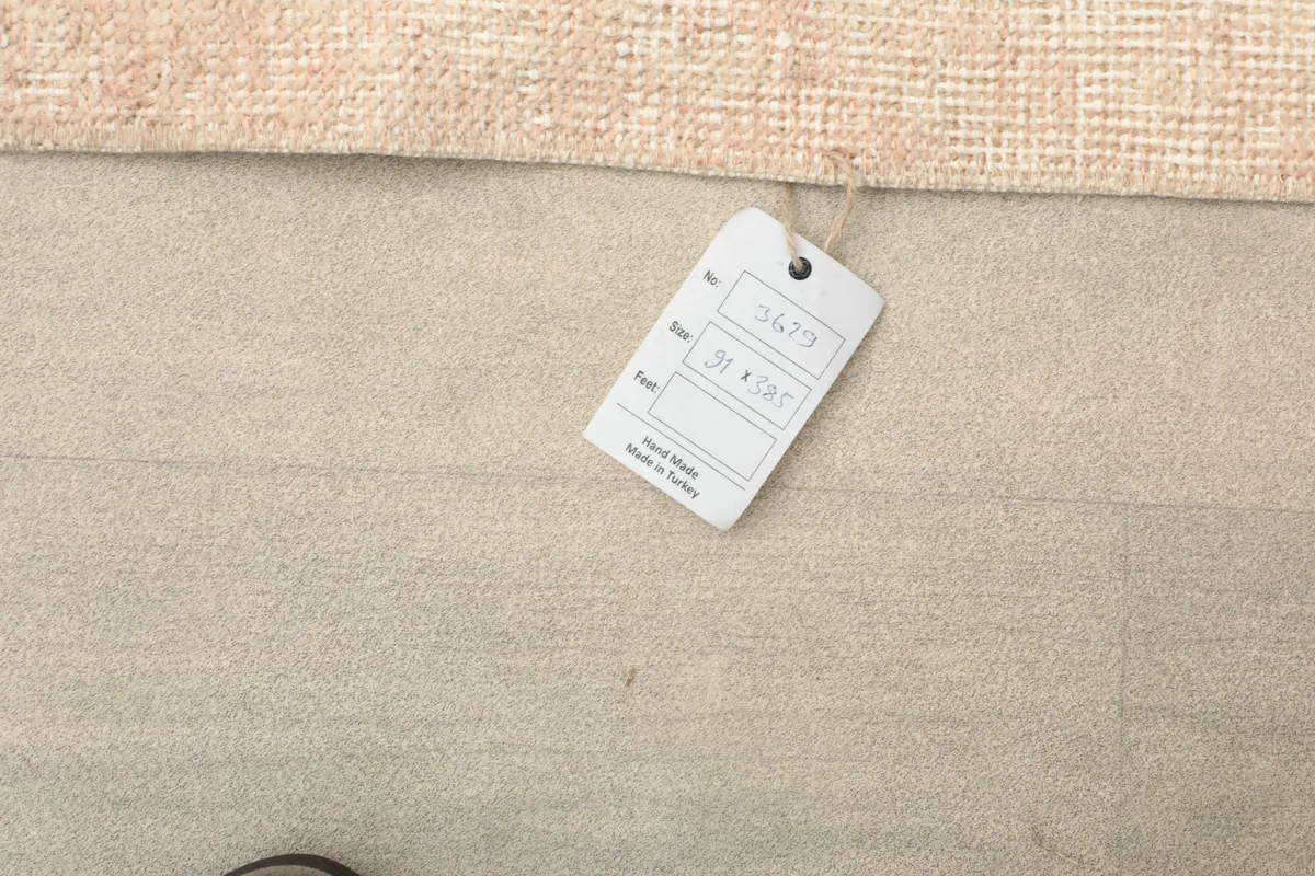 Close-up of the product tag attached to the rug, showing item details.
