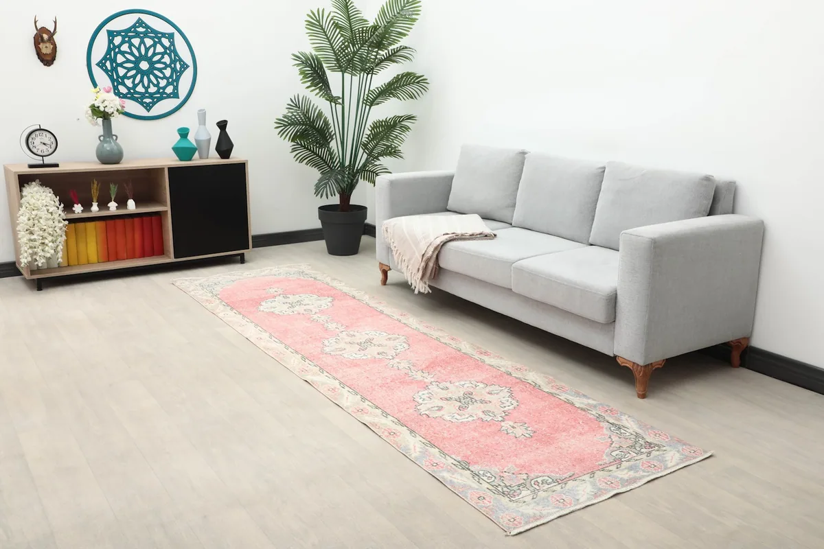 Wide shot of the pink runner rug in a room setting with furniture