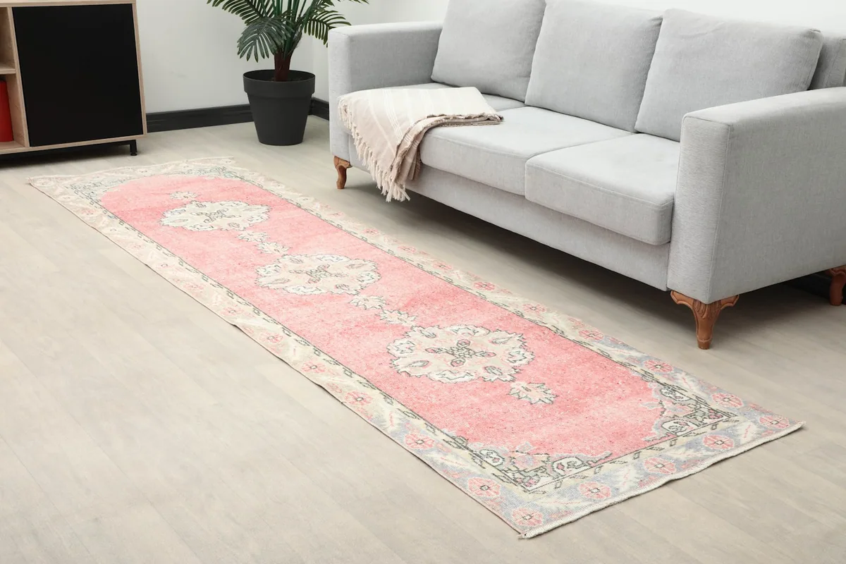 Angle view of the pink runner rug in a room, highlighting its placement