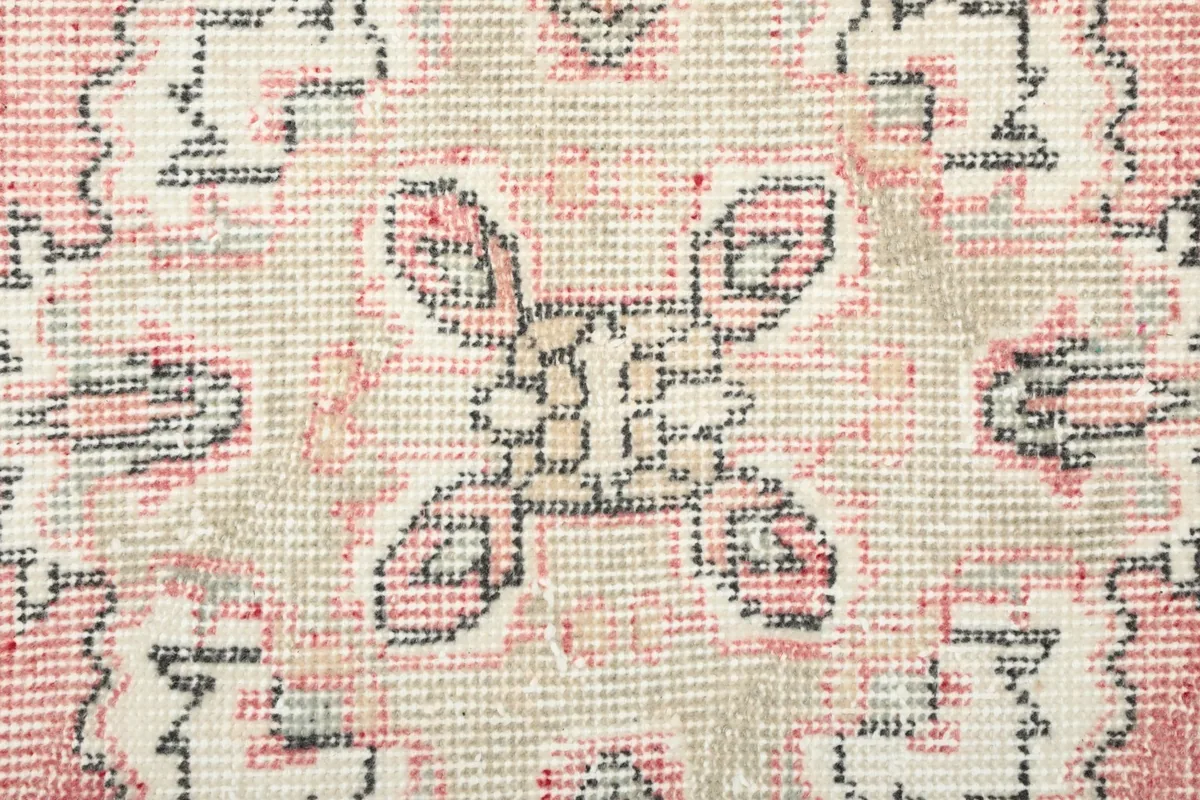 Extreme close-up showing the hand-knotted wool pile and texture of the rug