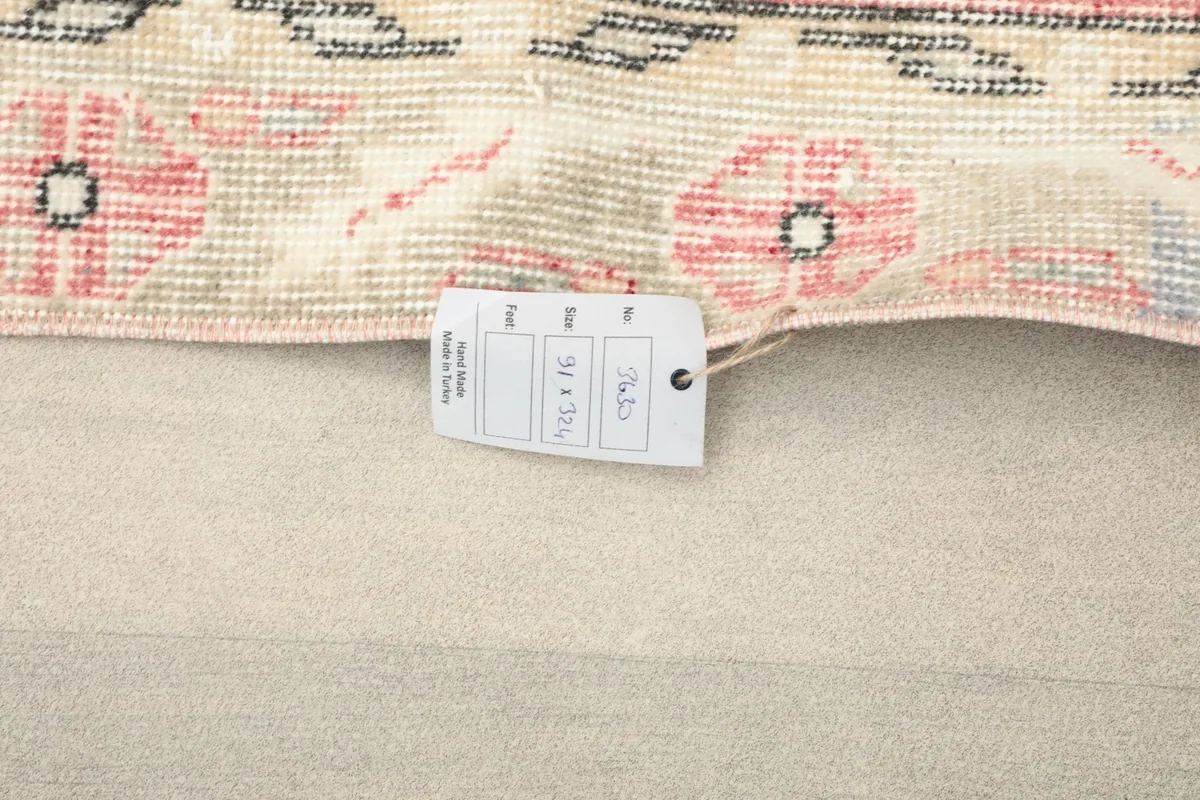Close-up of the rug's tag displaying size and origin information