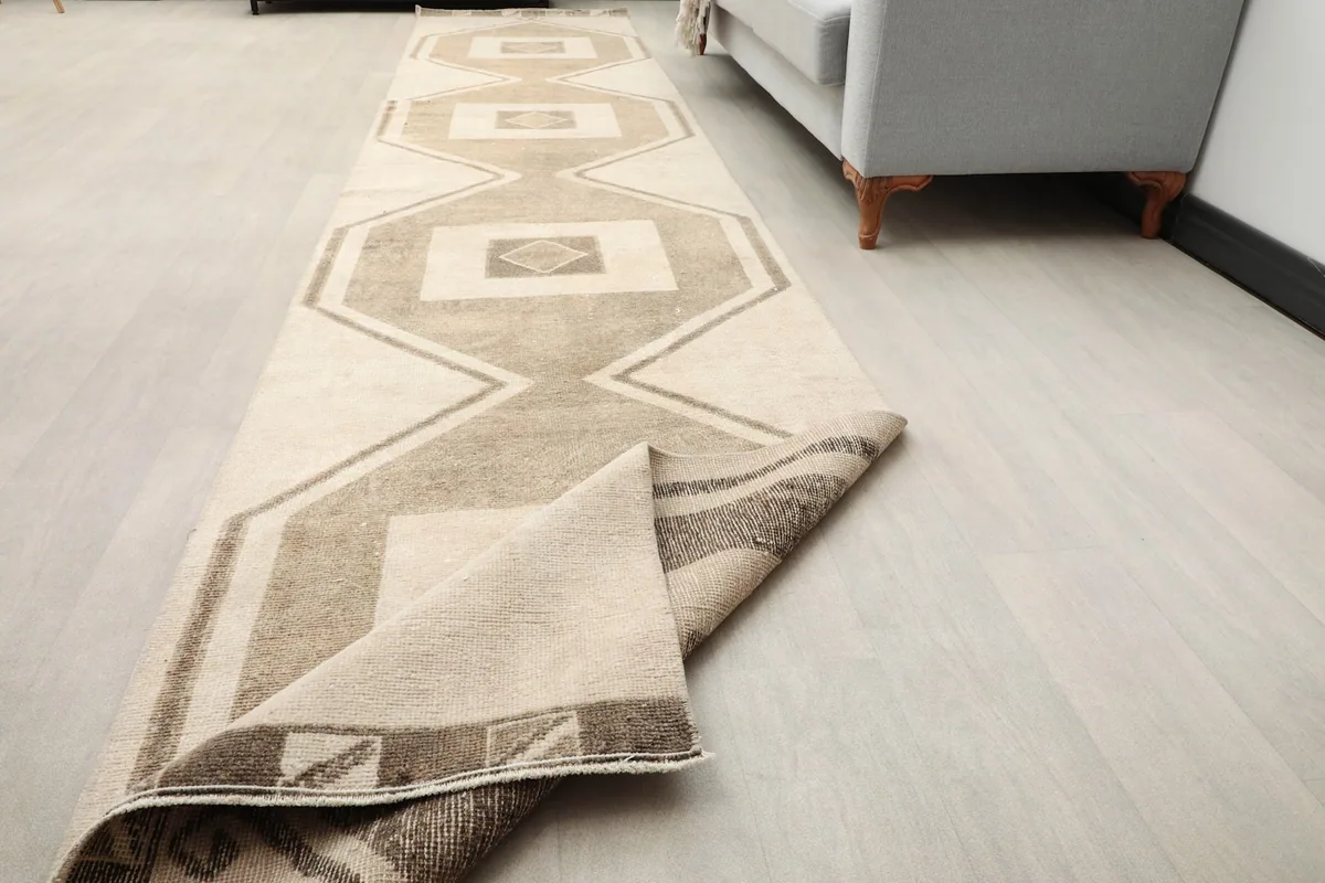 Runner rug partially folded, showcasing its flexibility and full length in a room.
