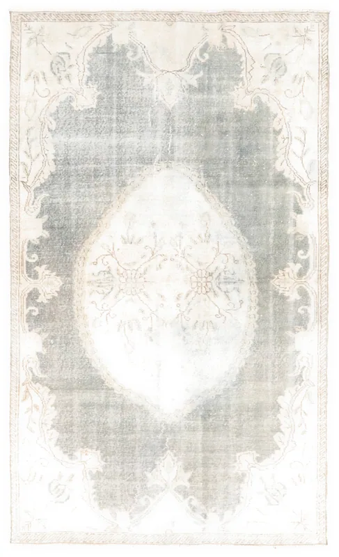 Full top view of the 4'11" x 8'4" vintage Anatolian rug with a muted gray field and ivory medallion