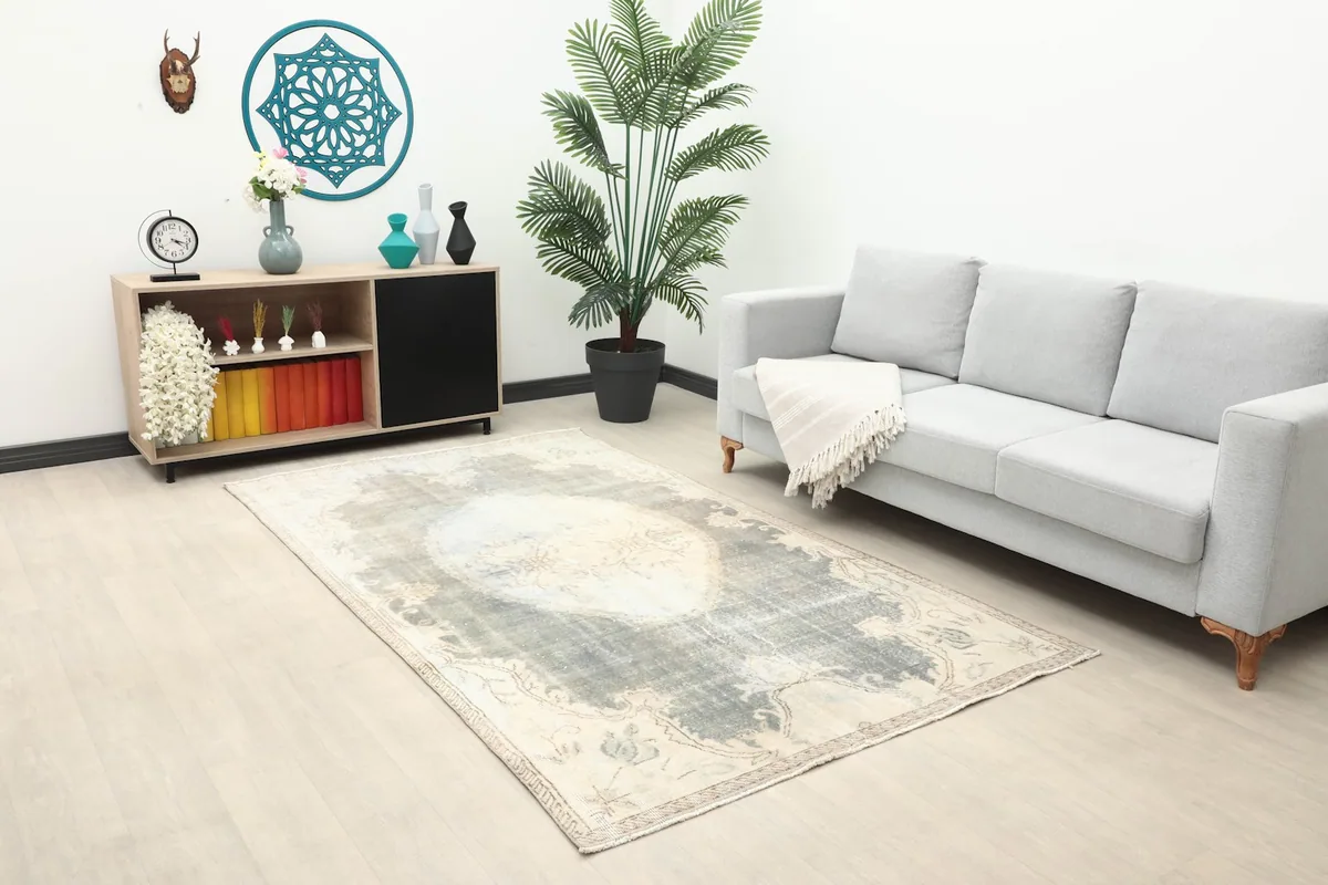 Overhead view of the vintage Anatolian rug in a modern living room with a console table and sofa