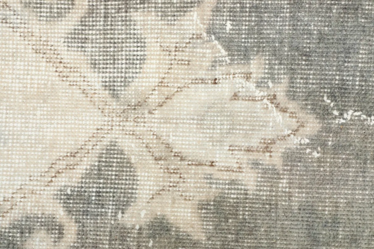 Texture detail showing the low wool pile and subtle variations in the gray and ivory colors