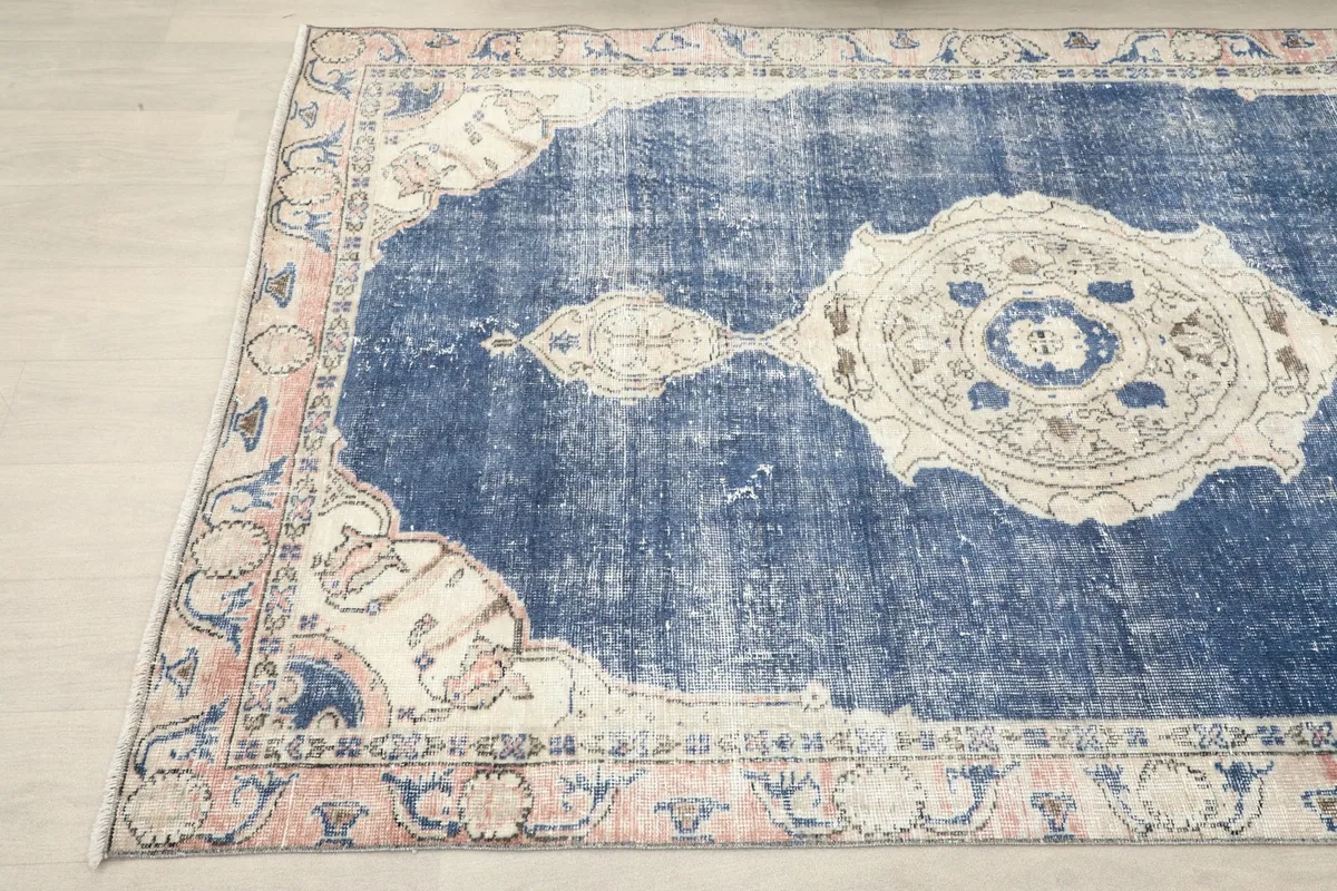 Another angle shot highlighting the border details and distressed navy pile.