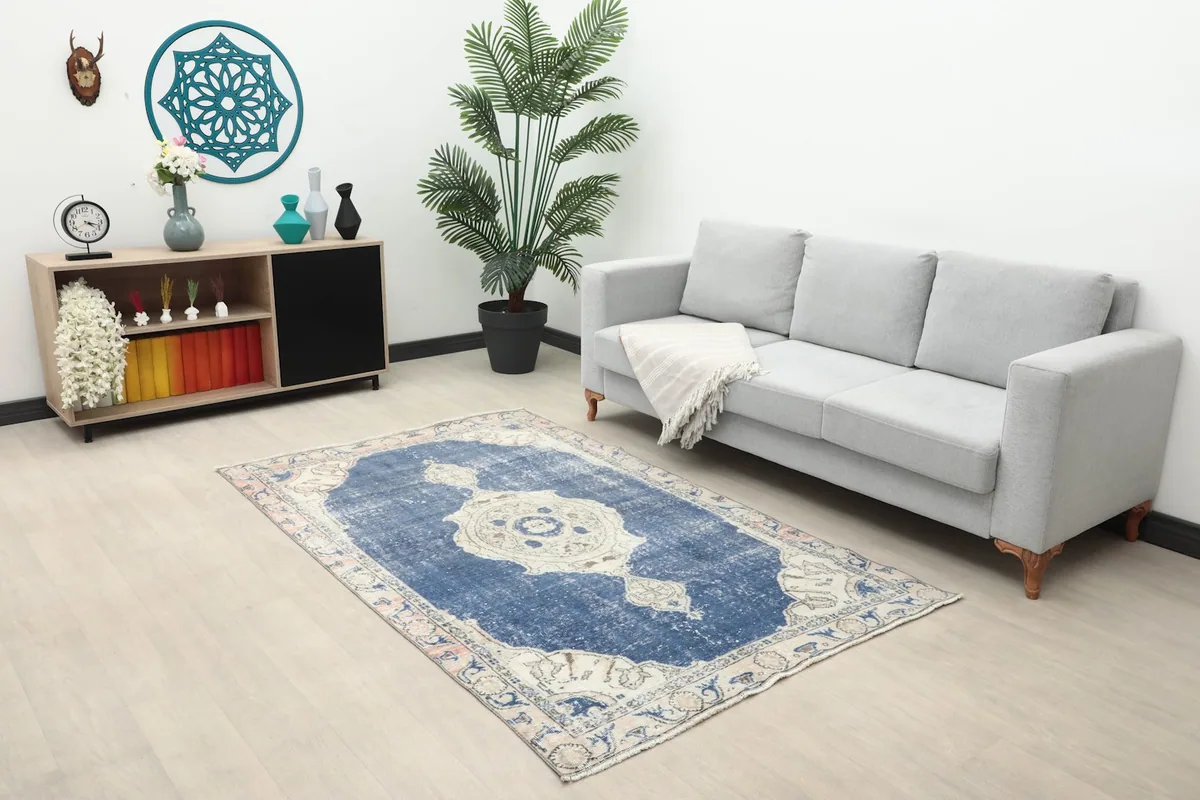 Overhead view of the small navy and beige rug placed in a modern living space.