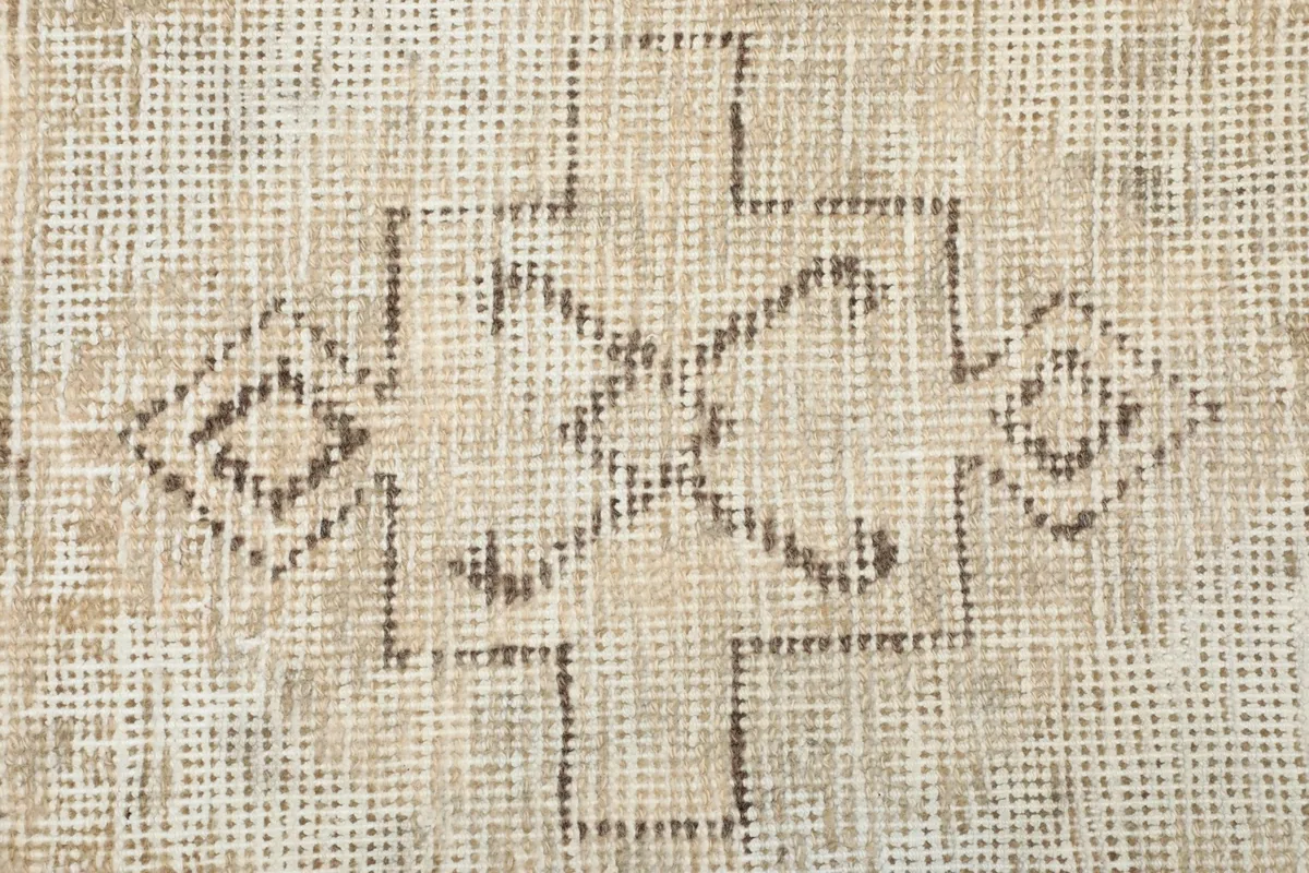 Detailed view of a smaller, faded tribal motif, showing the character of the vintage weave.