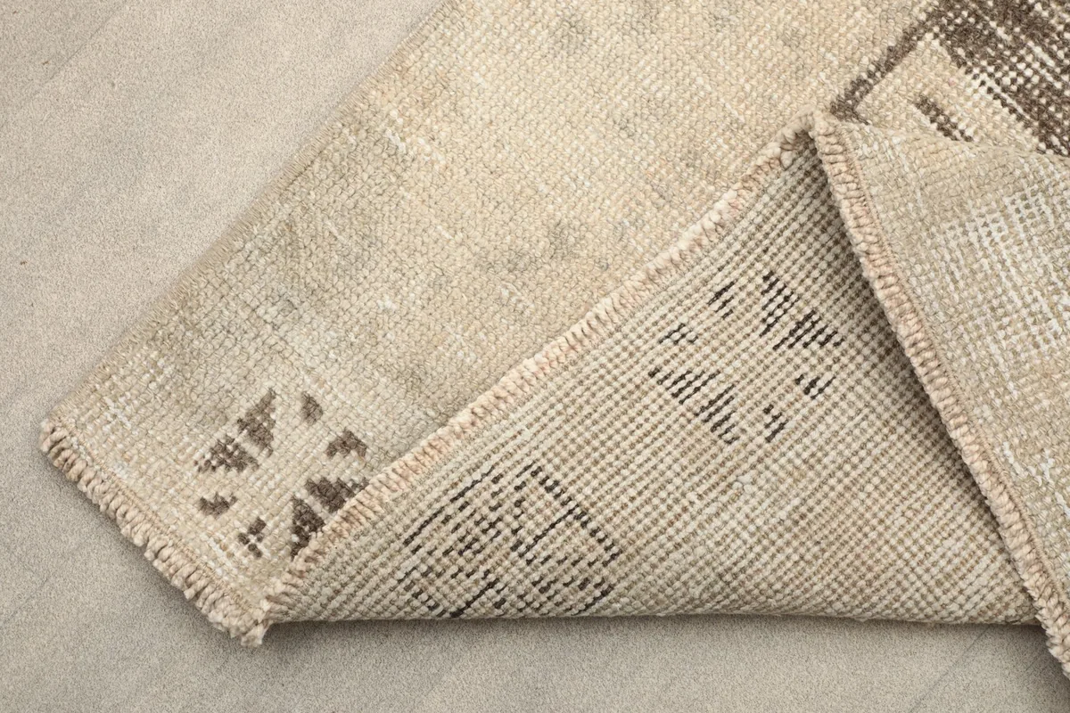 Underside view of the rug, revealing the cotton foundation and hand-knotted construction.