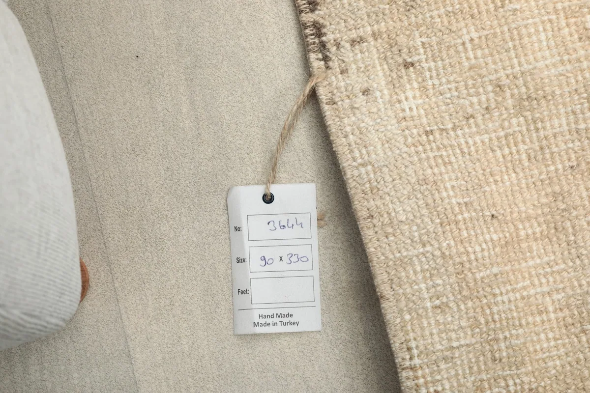 Close-up of the rug tag, displaying 'Hand Made' and 'Made in Turkey' details.