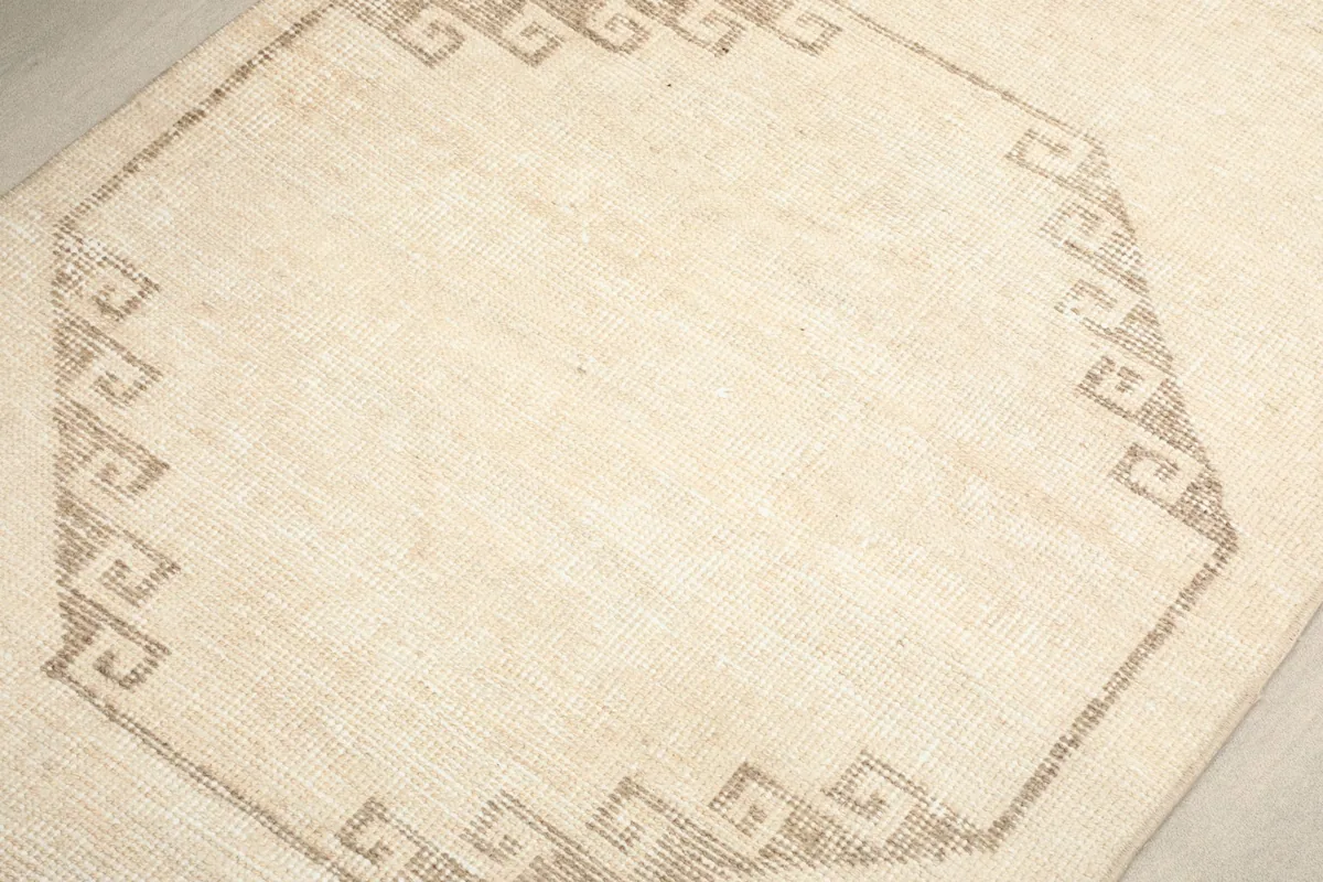 Close-up of the intricate brown geometric border surrounding a beige octagonal shape