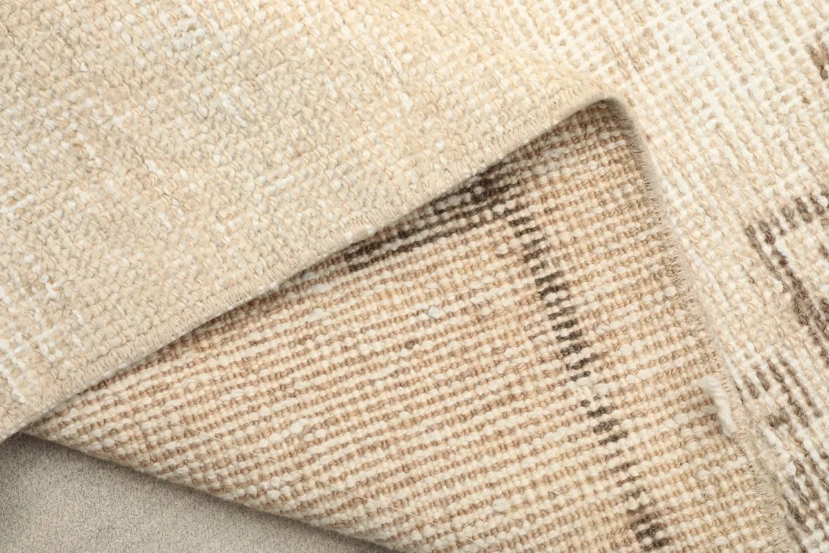 Underside of the rug revealing the tightly woven cotton foundation and knots
