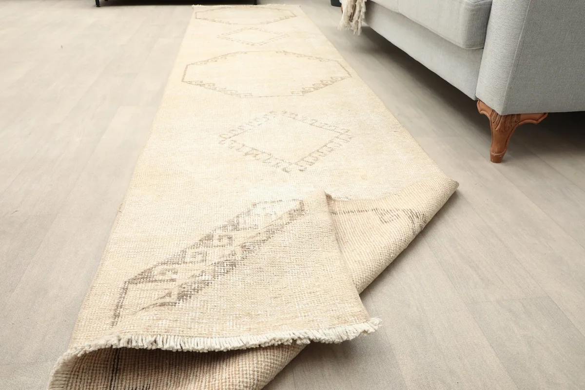 Rug partially rolled, showing the flexibility and construction from an angle