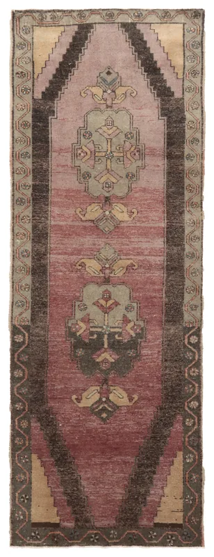 Top-down view of a 3'4" x 10'4" vintage Anatolian runner rug with rose field and black geometric motifs