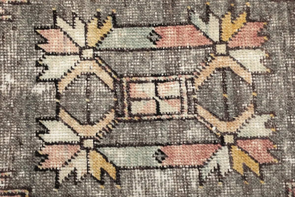 Macro detail of the hand-knotted wool pile, showing the texture and colors within a motif
