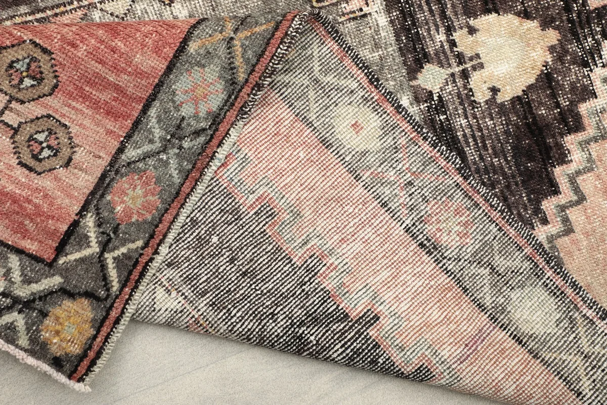 View of the back of the hand-knotted rug, showing the cotton foundation and knotting