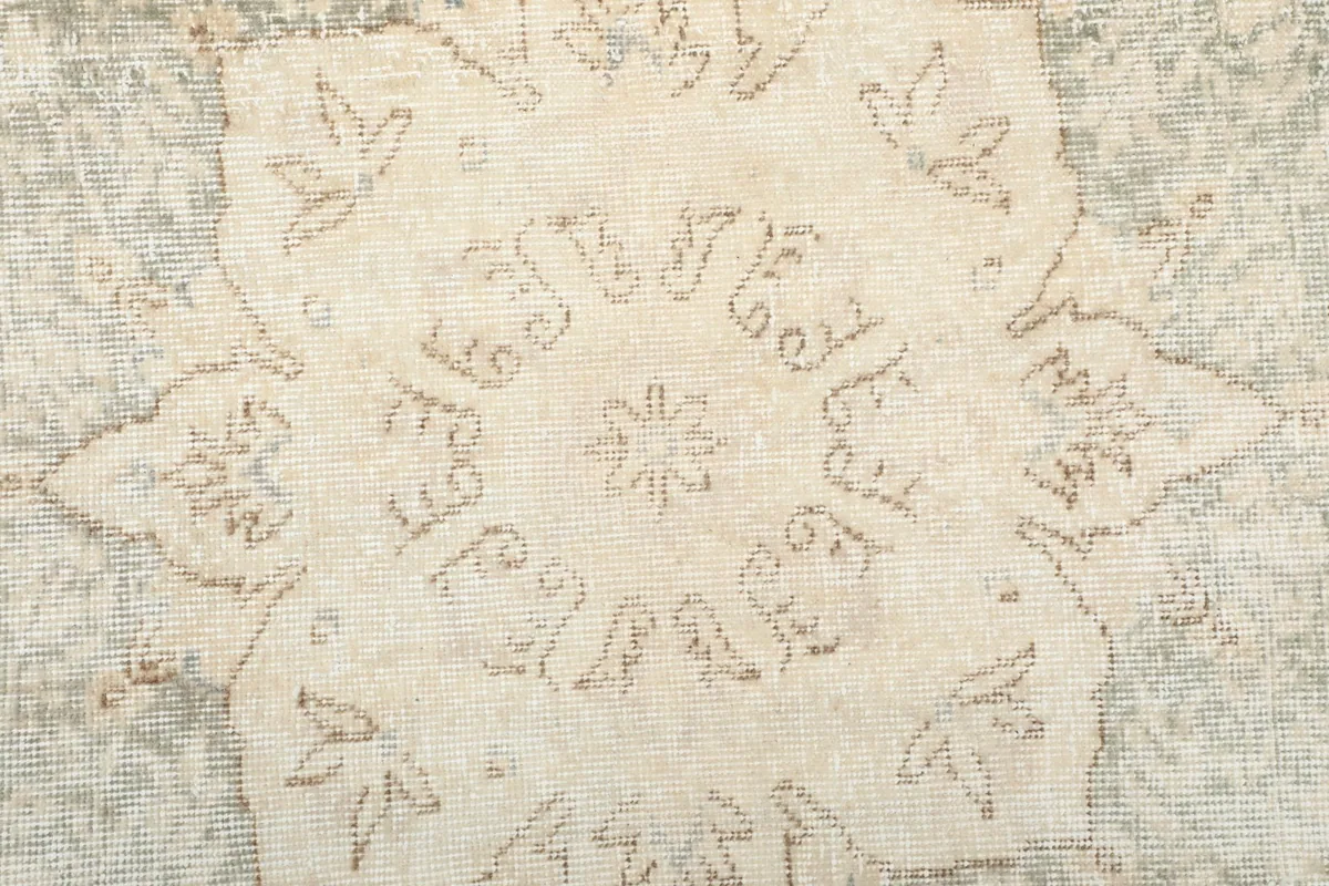 Close-up of the intricate design within the central medallion of the vintage rug