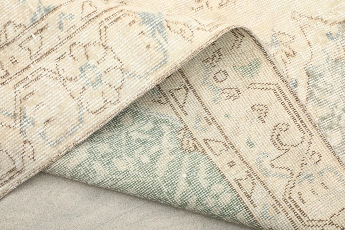 Detail of the rug's reverse side, revealing the wool pile on cotton foundation