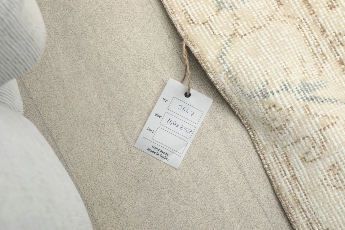 Close-up of the product tag attached to the rug, showing origin and size details