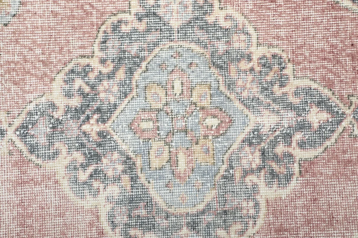 Macro shot of a gray medallion motif with subtle hints of blue and orange
