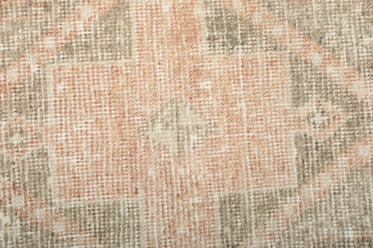View of the low wool pile texture and hand-knotted weave of the runner rug