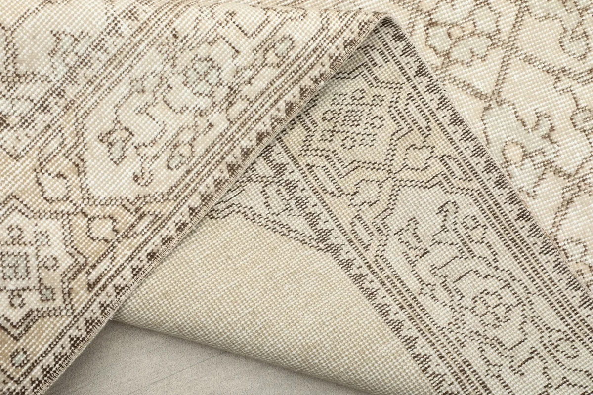 View of the back of the hand-knotted rug, revealing the cotton foundation and knotting.