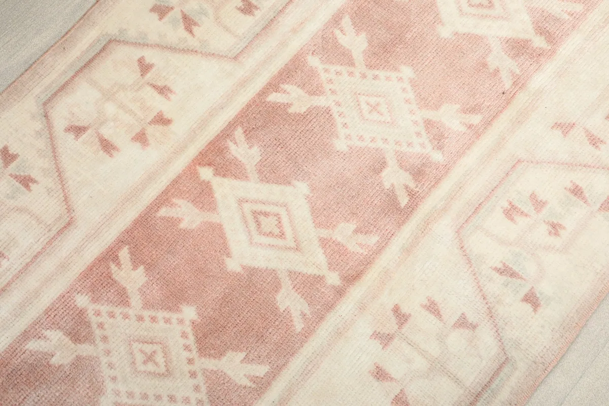 Angled close-up showing the geometric patterns and color variations in the wool pile