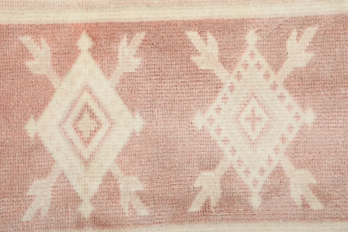 Very close view of the low wool pile and hand-knotted geometric motifs