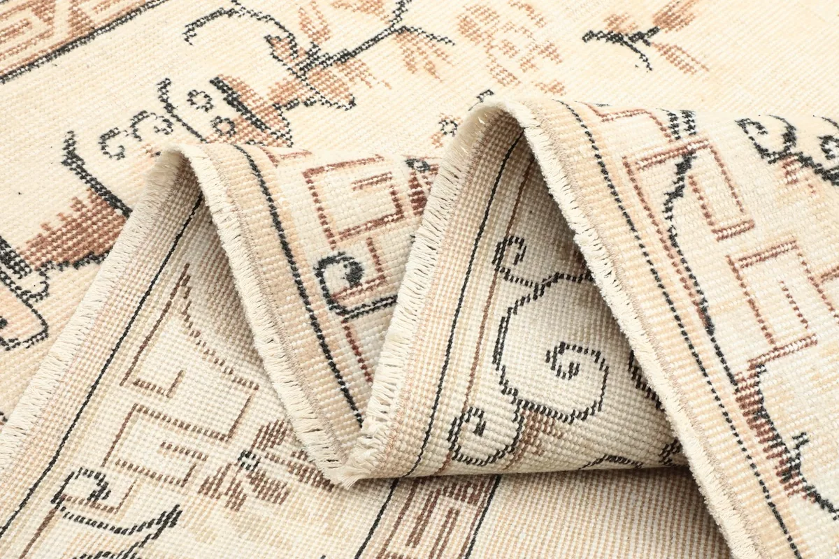 Rug folded to show the texture and construction, highlighting the border and field patterns.