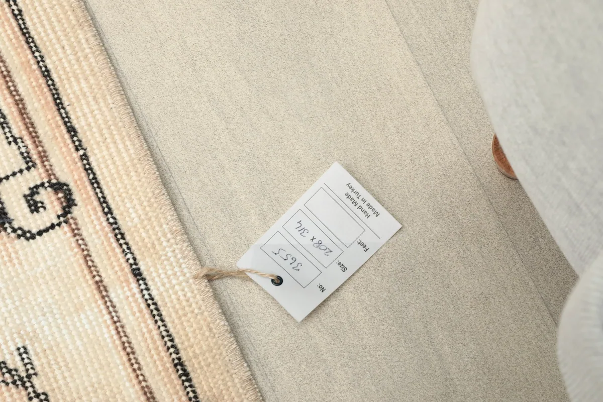 Product tag attached to the rug, showing size and other details.
