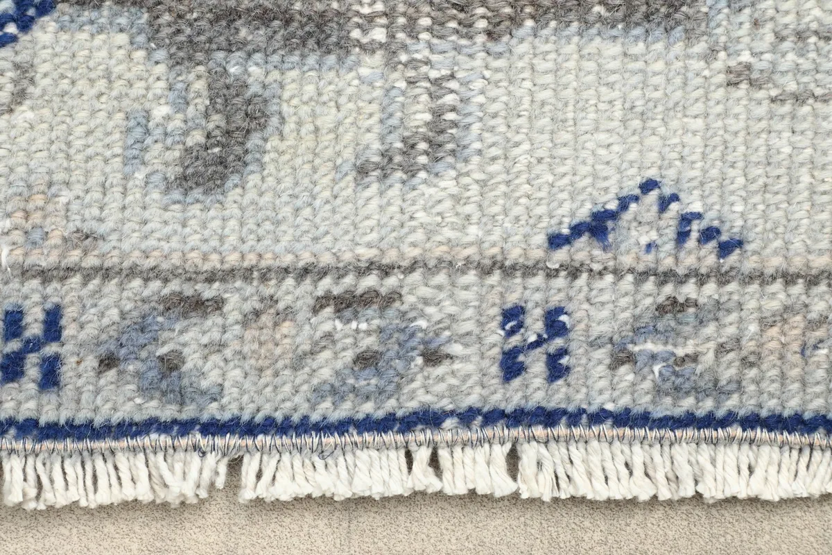 Close-up of the rug's fringe and a section of the border pattern