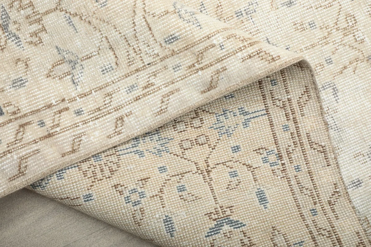 Close-up of the rug's underside, revealing the hand-knotted cotton foundation.