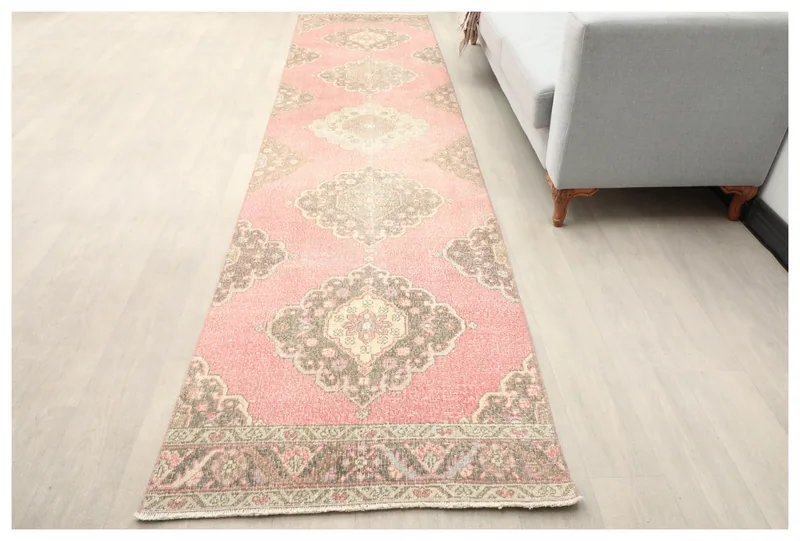 Full top view of the 2'11" x 12'4" rose and brown vintage Anatolian runner rug on a white background.