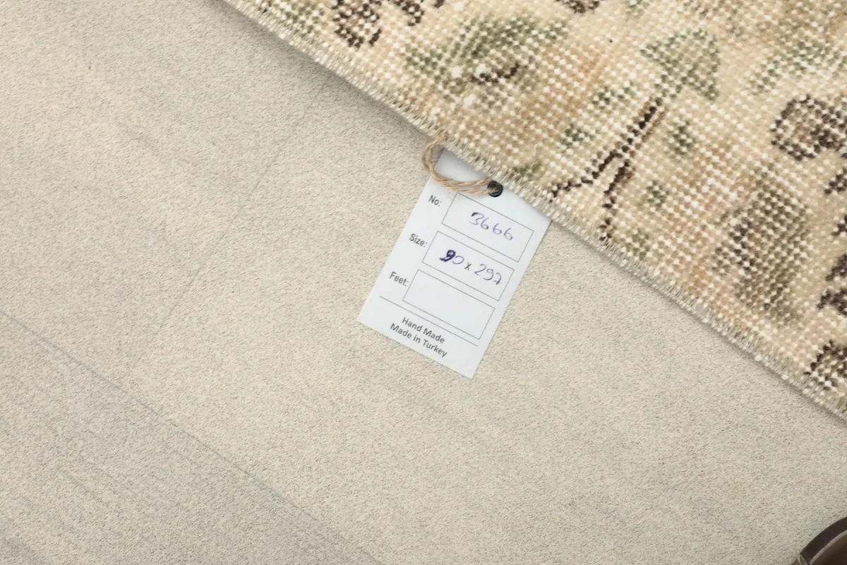 Rug corner with a label showing dimensions and origin, highlighting the hand-knotted craftsmanship