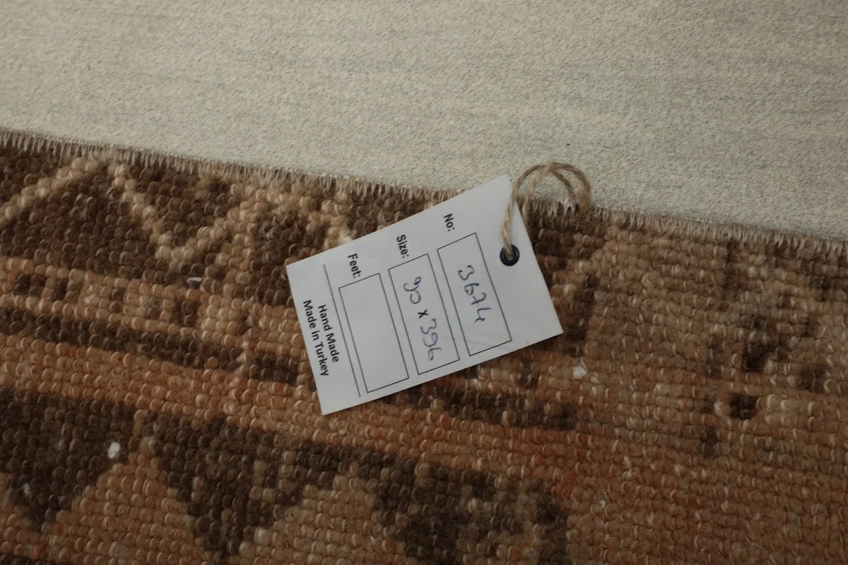 Close-up of the rug's label confirming it is handmade in Turkey with size details