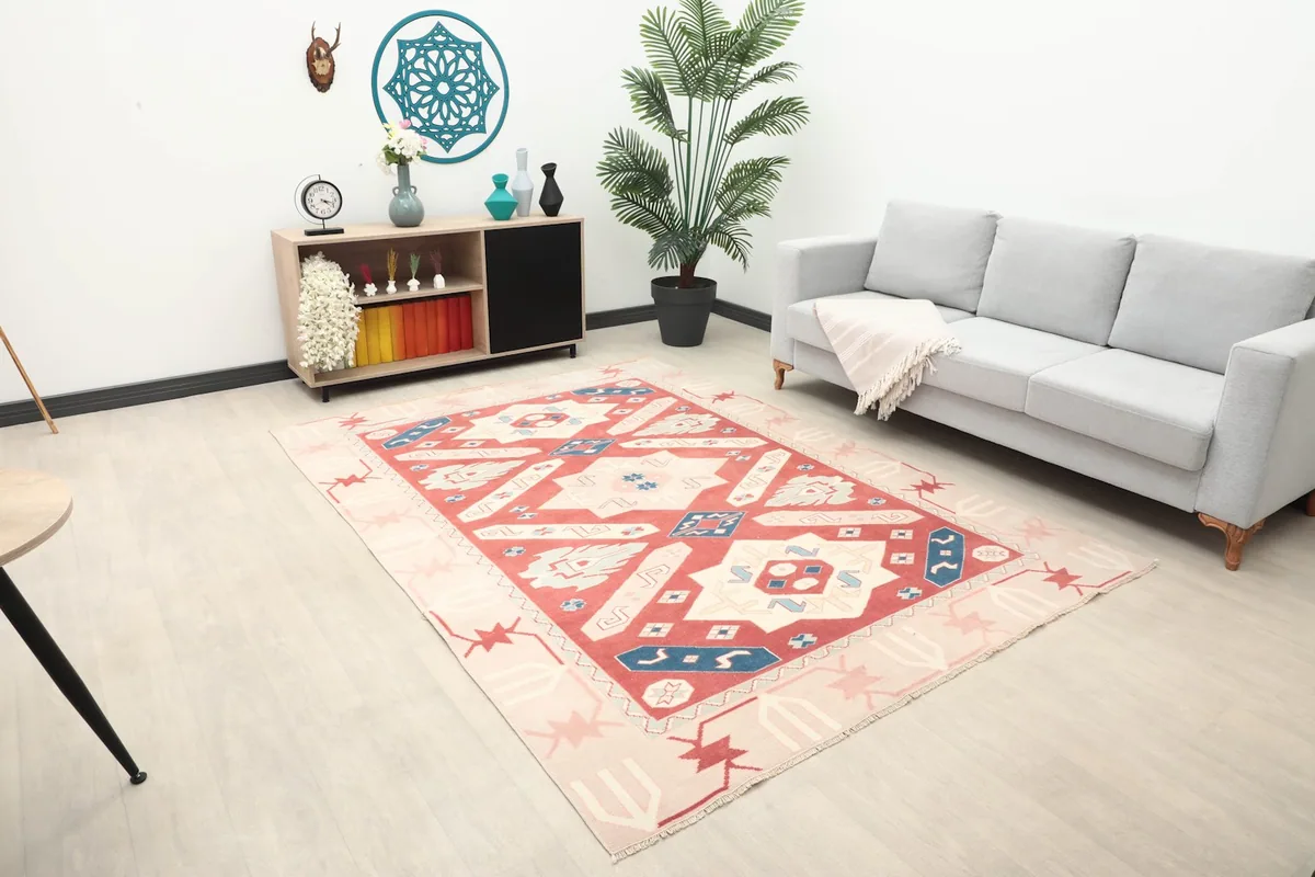 Wide angle view of the red and ivory geometric rug placed in a contemporary living space