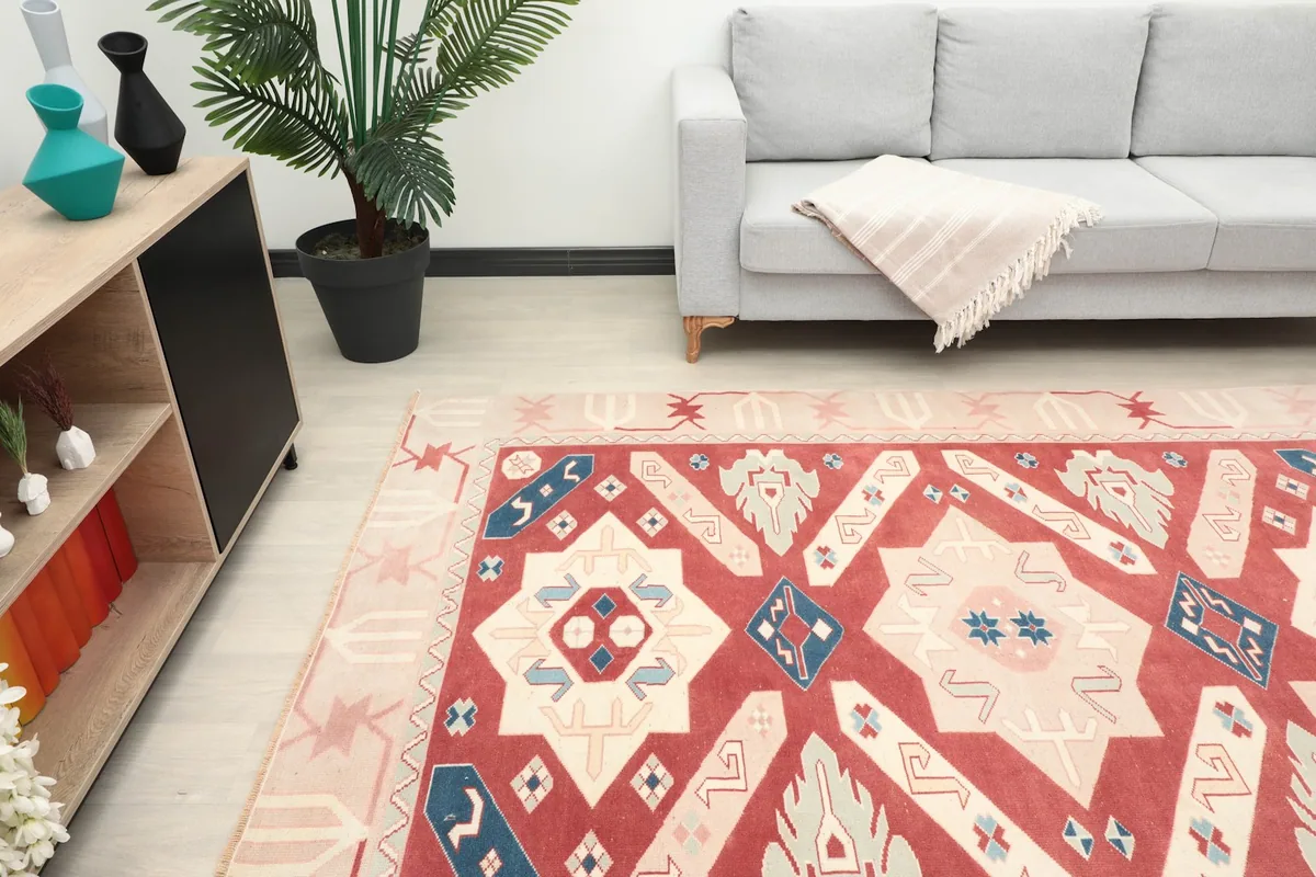 Overhead view of the rug in a living room, focusing on the central design and color palette