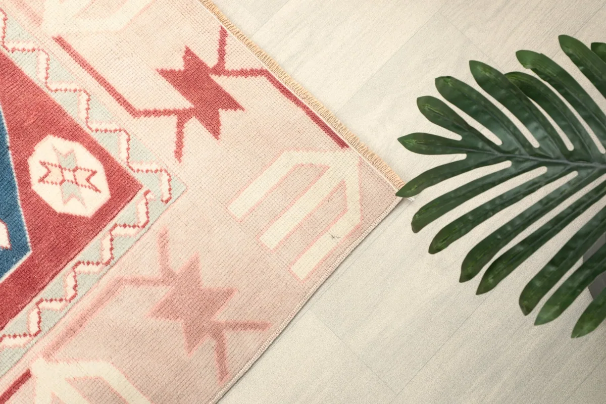 Detailed shot of the ivory border with subtle red geometric elements and the corner design