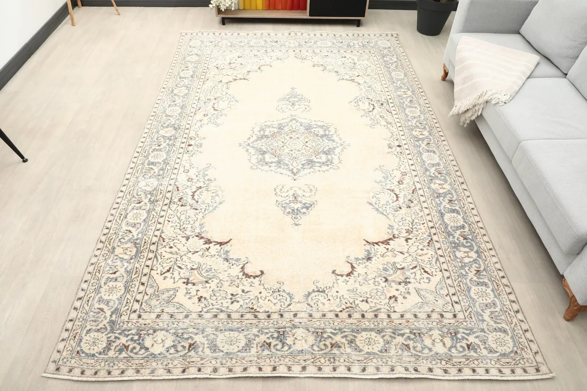 Vintage area rug in a living room setting with a gray sofa