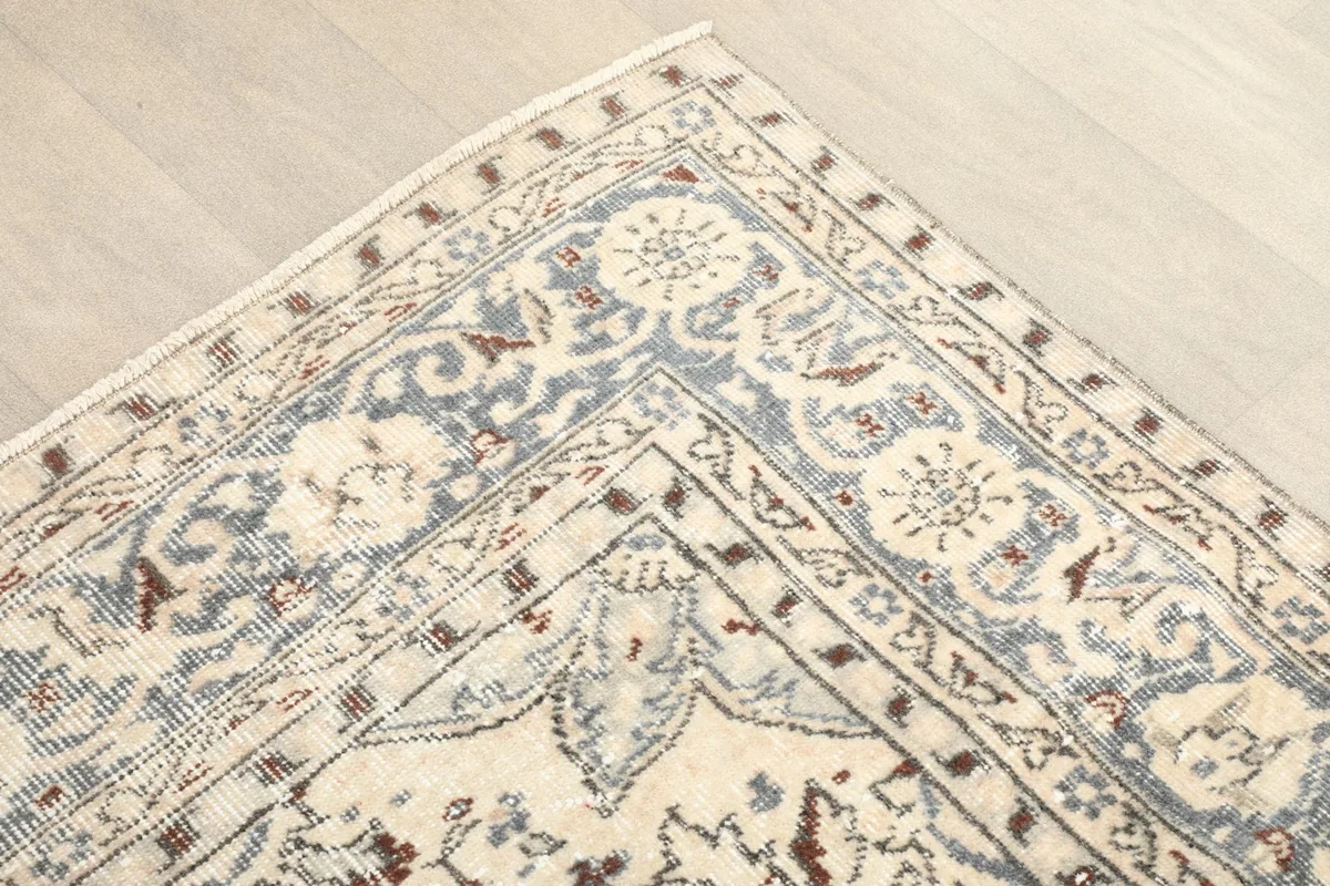 Corner detail showing the blue and ivory floral border pattern