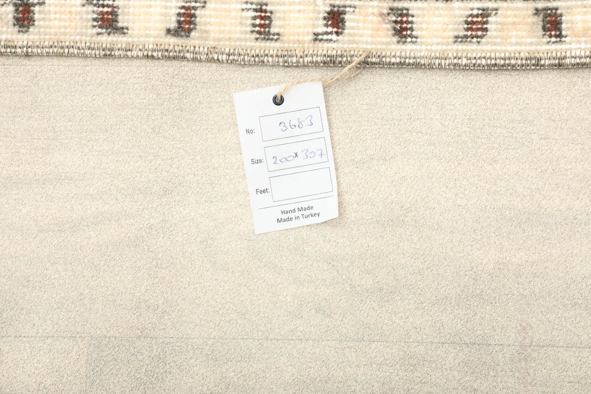 Back of the rug with a label, showing the cotton foundation