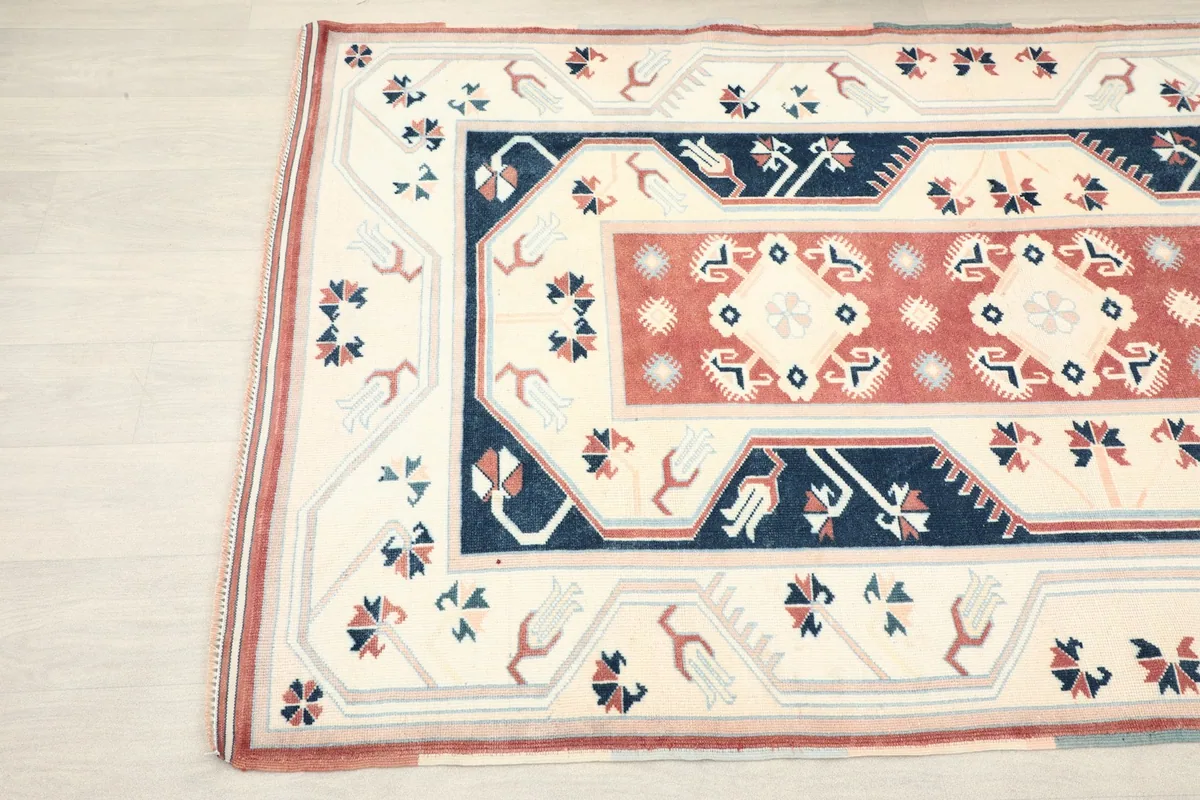 Angled view highlighting the intricate patterns and colors in the rug's border and field